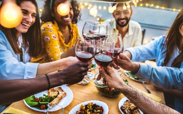 People,Toasting,Red,Wine,Glasses,On,Rooftop,Dinner,Party,-