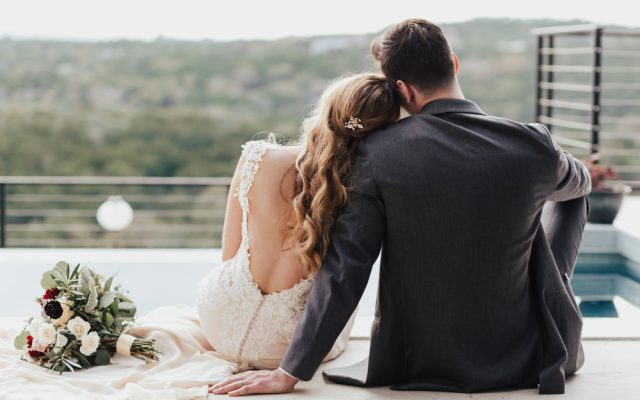 Back,View,Of,A,Couple,Sitting,In,An,Embrace,Looking